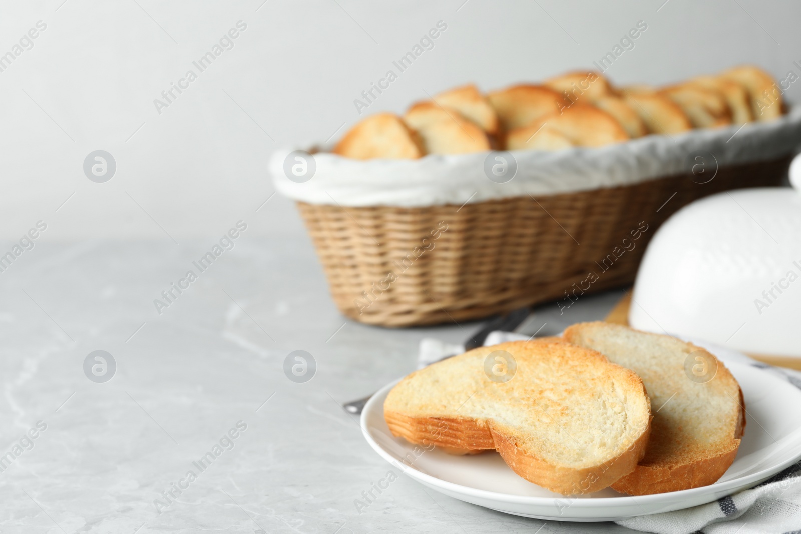 Photo of Slices of toasted bread on grey table. Space for text