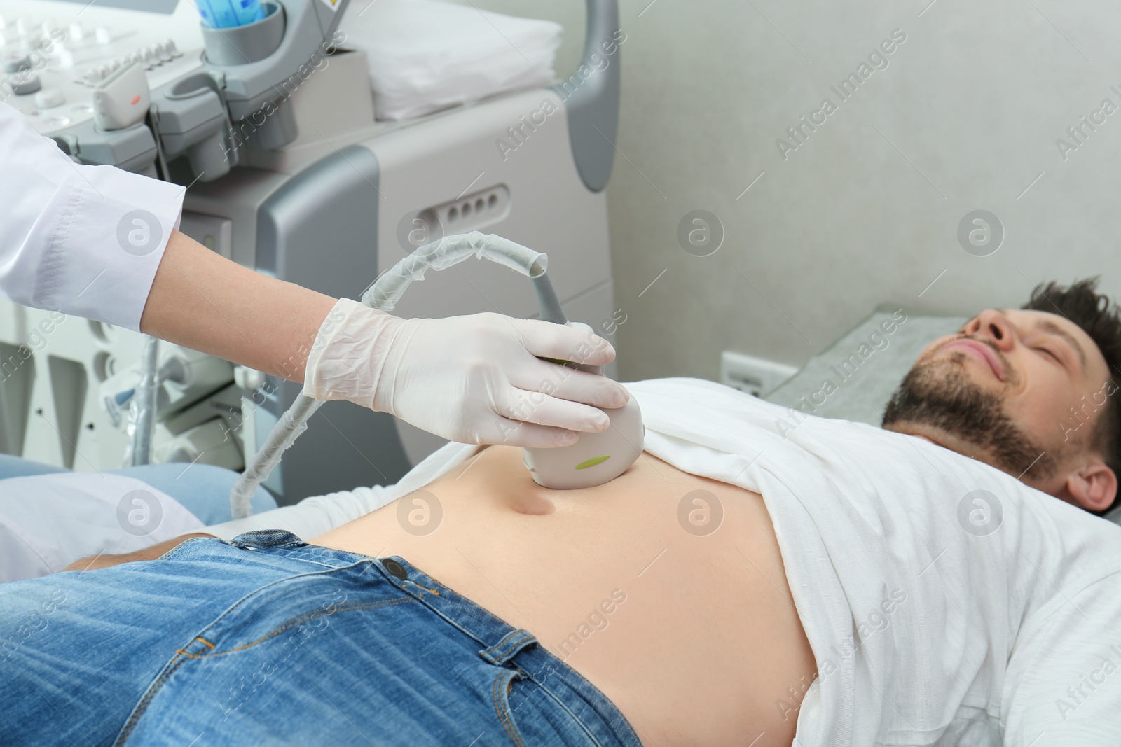 Photo of Doctor conducting ultrasound examination of internal organs in clinic