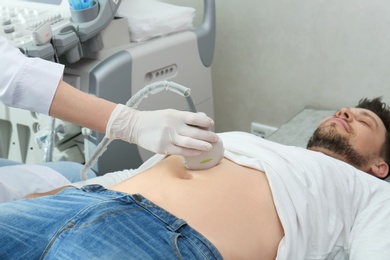 Doctor conducting ultrasound examination of internal organs in clinic