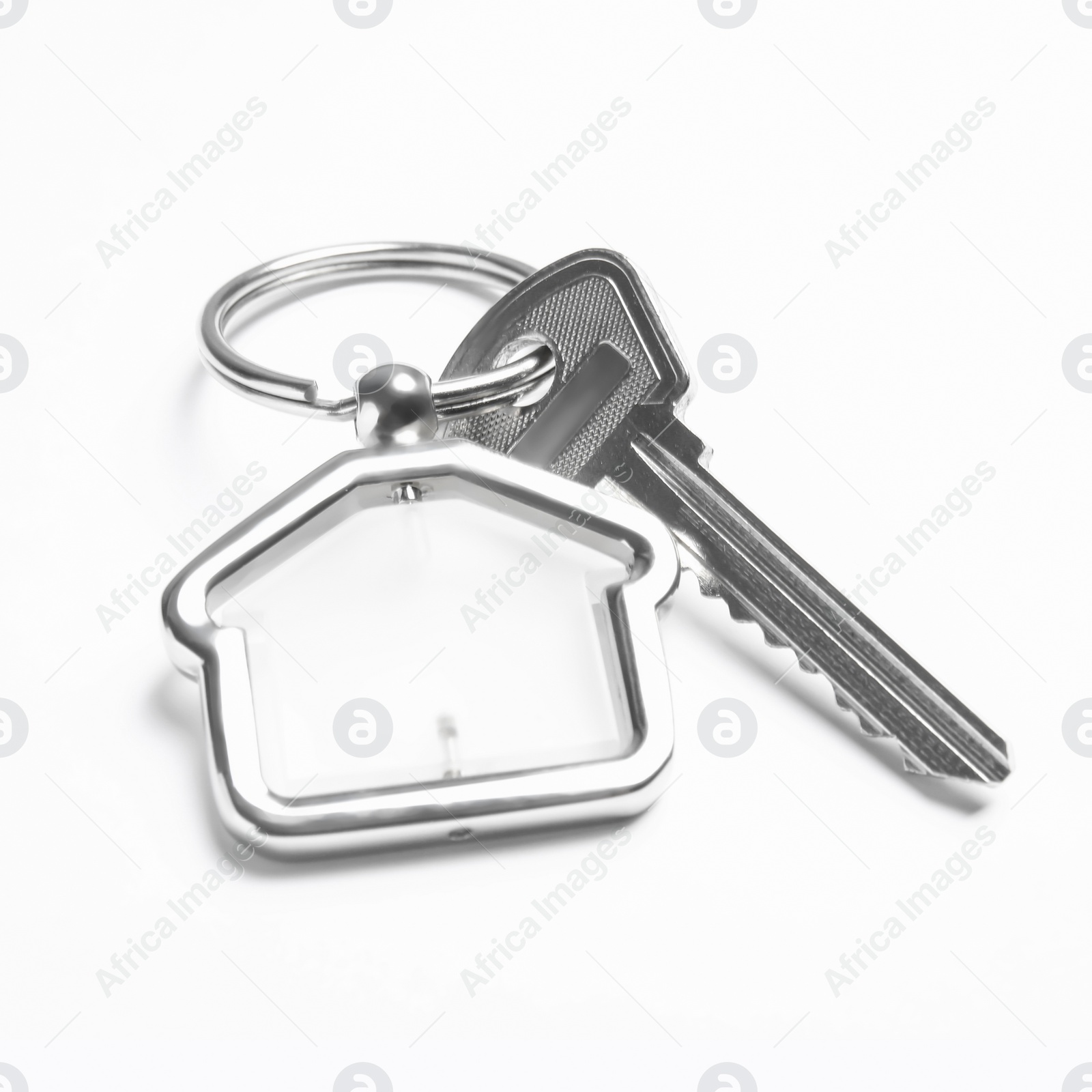 Photo of House key with trinket on white background