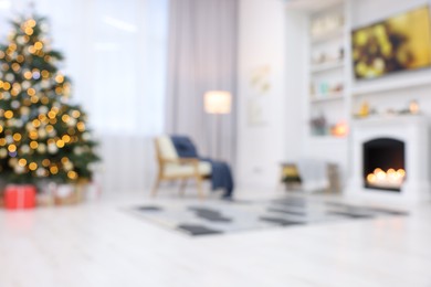 Photo of Blurred view of beautiful Christmas tree with festive lights in living room