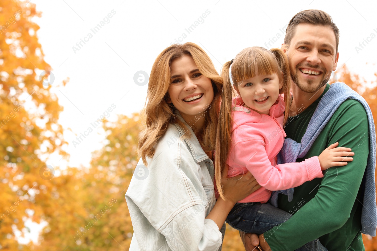 Photo of Happy family with child together in park. Autumn walk