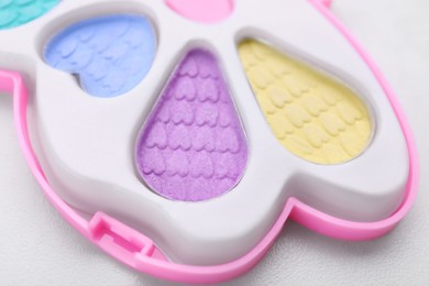Photo of Decorative cosmetics for kids. Eye shadow palette on white table, closeup