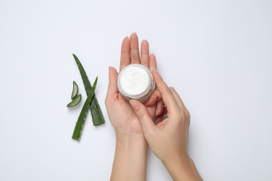 Photo of Woman with cosmetic product and aloe on white background, top view
