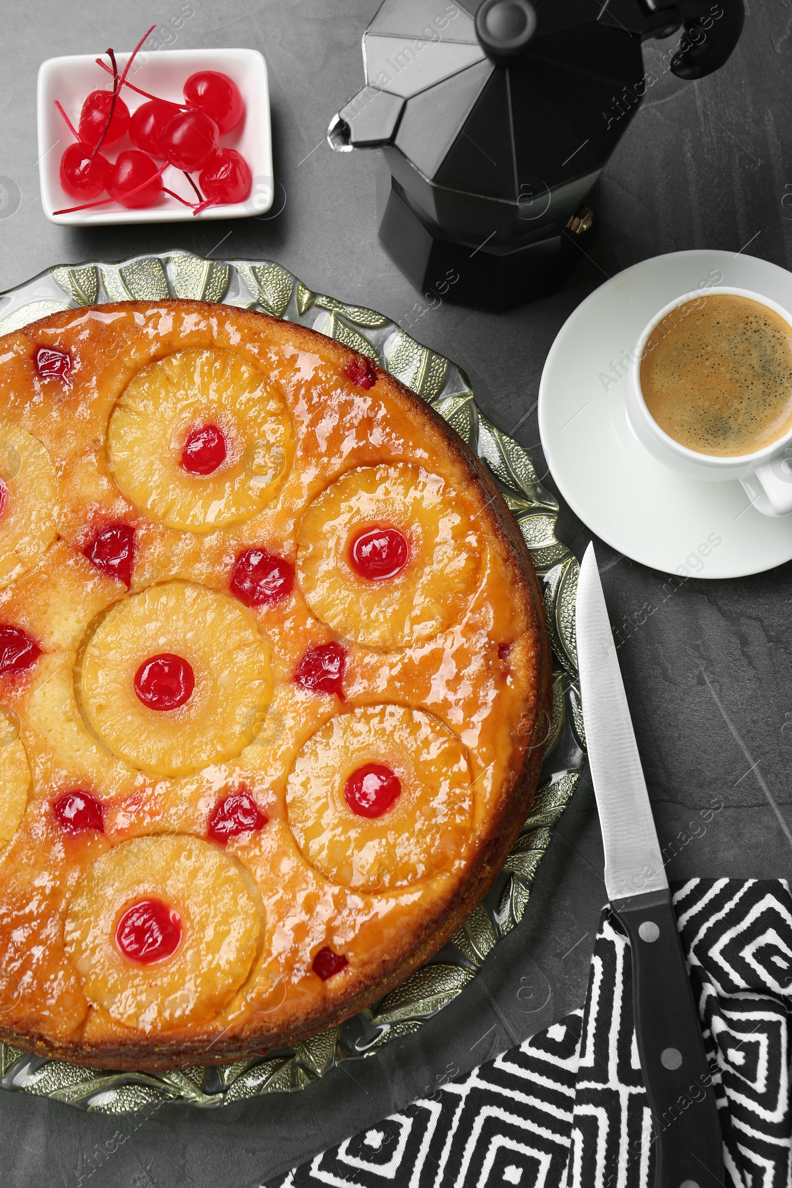 Photo of Flat lay composition with tasty pineapple cake on grey textured table