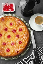 Flat lay composition with tasty pineapple cake on grey textured table