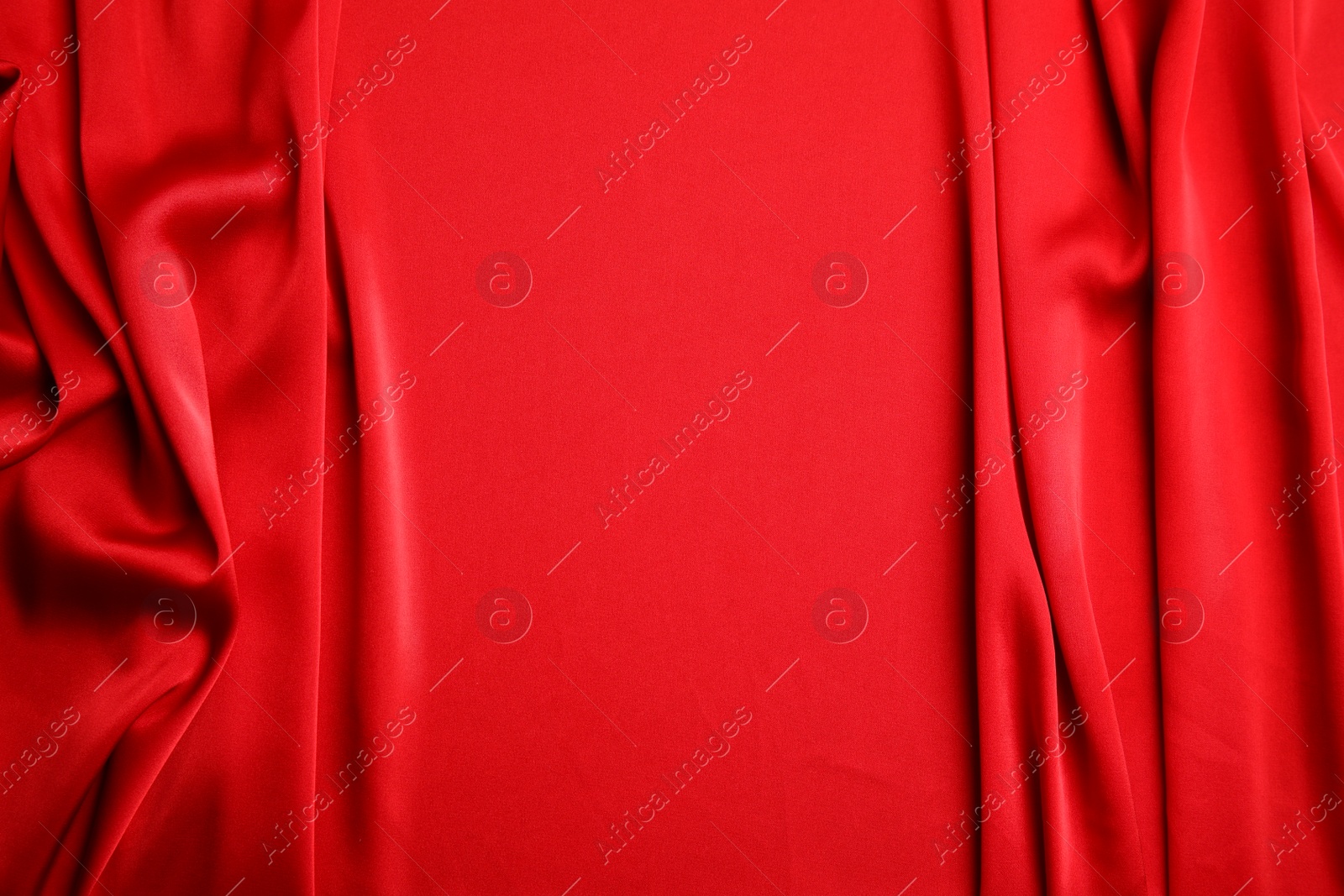 Photo of Texture of delicate red silk as background, top view