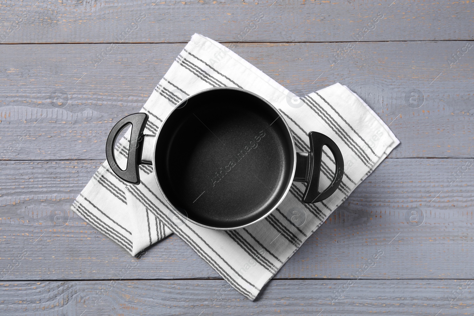 Photo of Empty pot on grey wooden table, top view