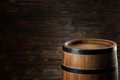 Photo of One wooden barrel near wall, closeup. Space for text