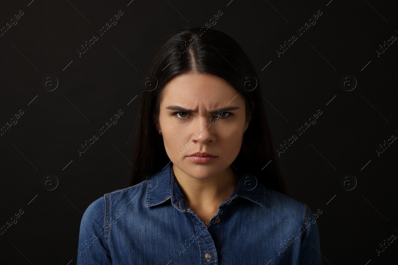 Photo of Personality concept. Emotional woman on black background