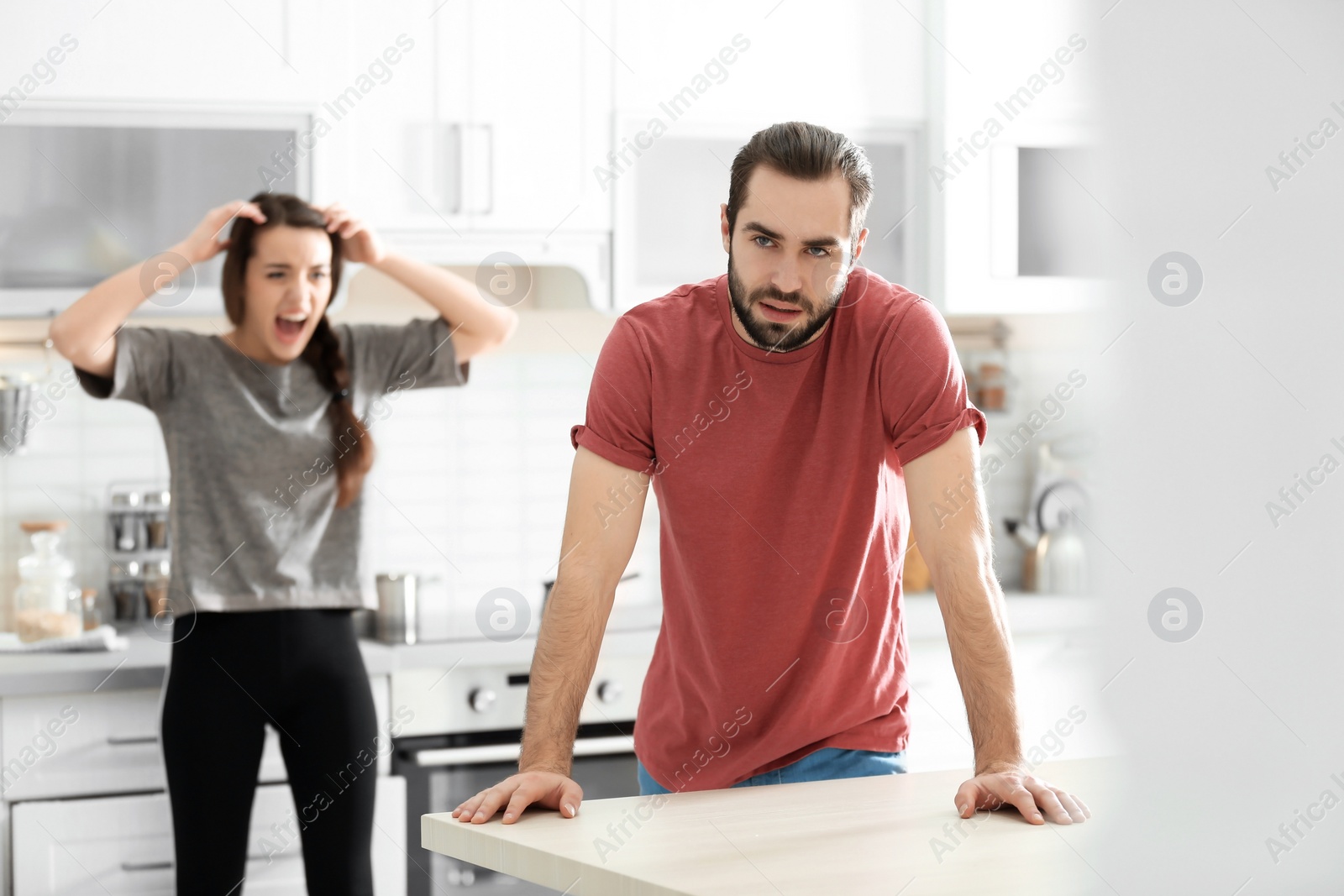 Photo of Young couple having argument in kitchen