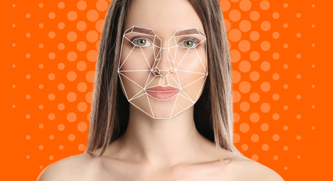 Facial recognition system. Woman with digital biometric grid on orange background