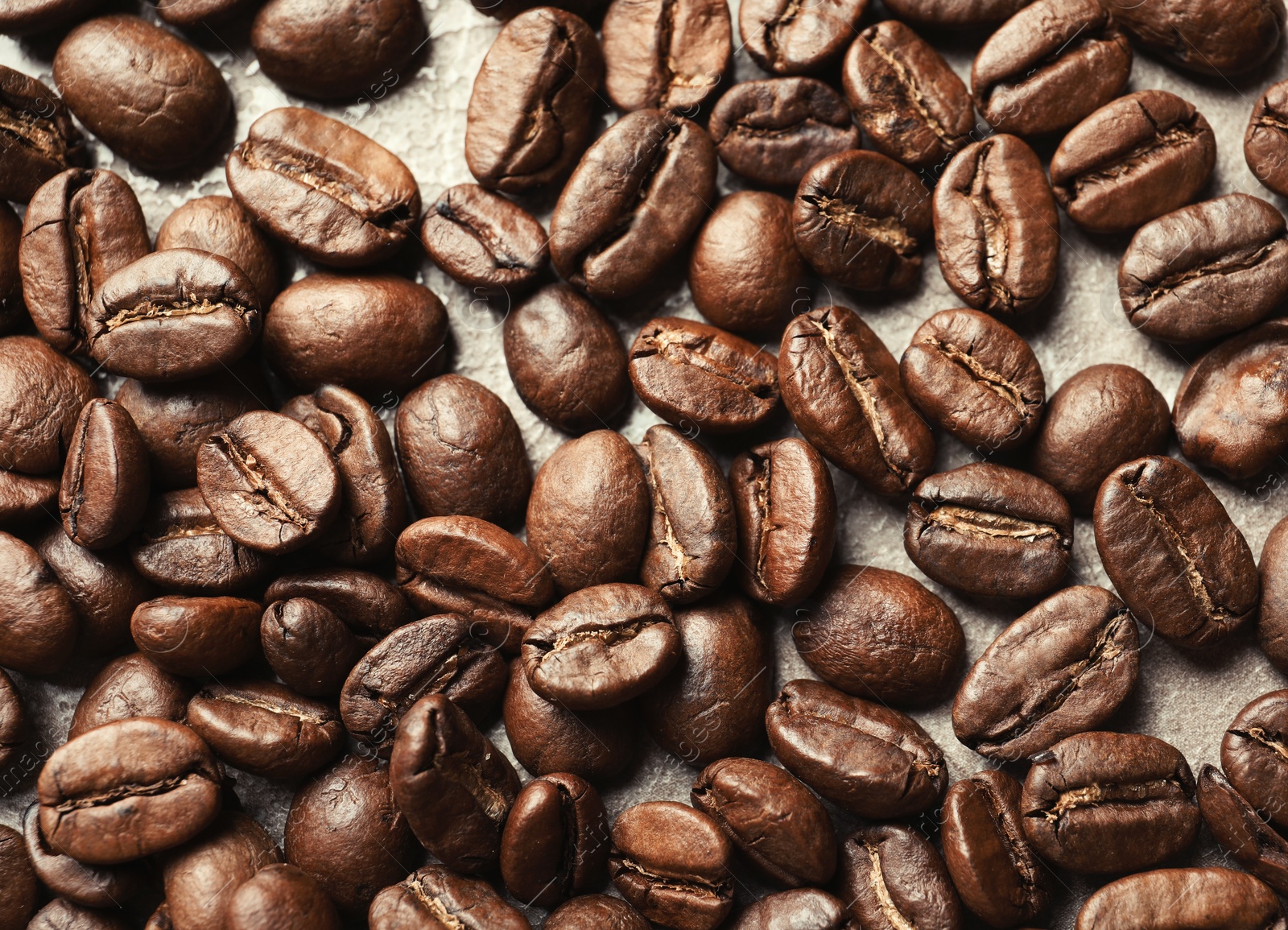 Photo of Roasted coffee beans on grey background, closeup