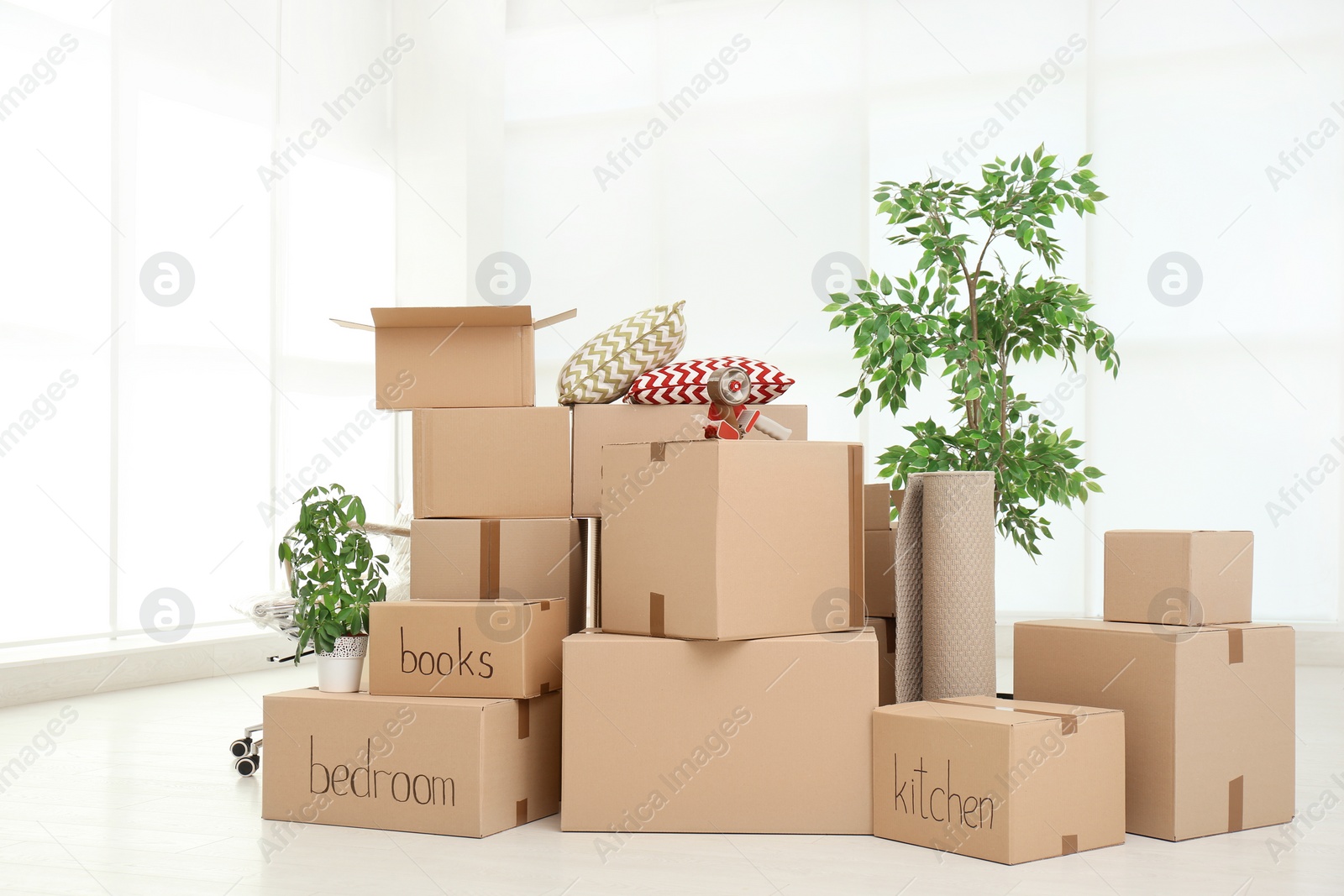 Photo of Pile of moving boxes in empty room