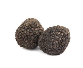 Photo of Fresh whole black truffles isolated on white