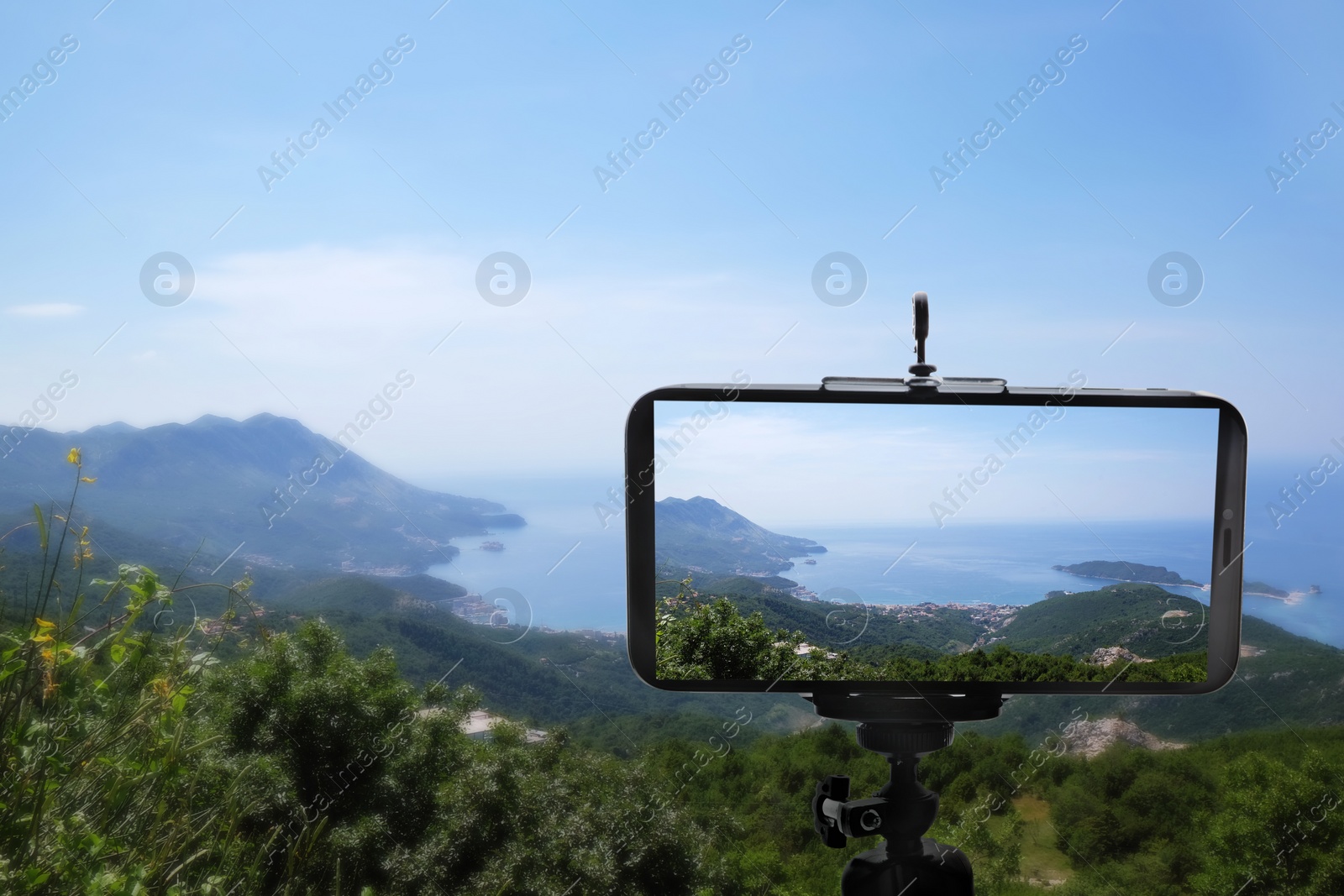 Image of Taking photo of beautiful mountain landscape with smartphone mounted on tripod