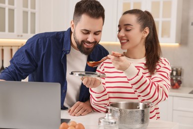 Happy lovely couple cooking together in kitchen