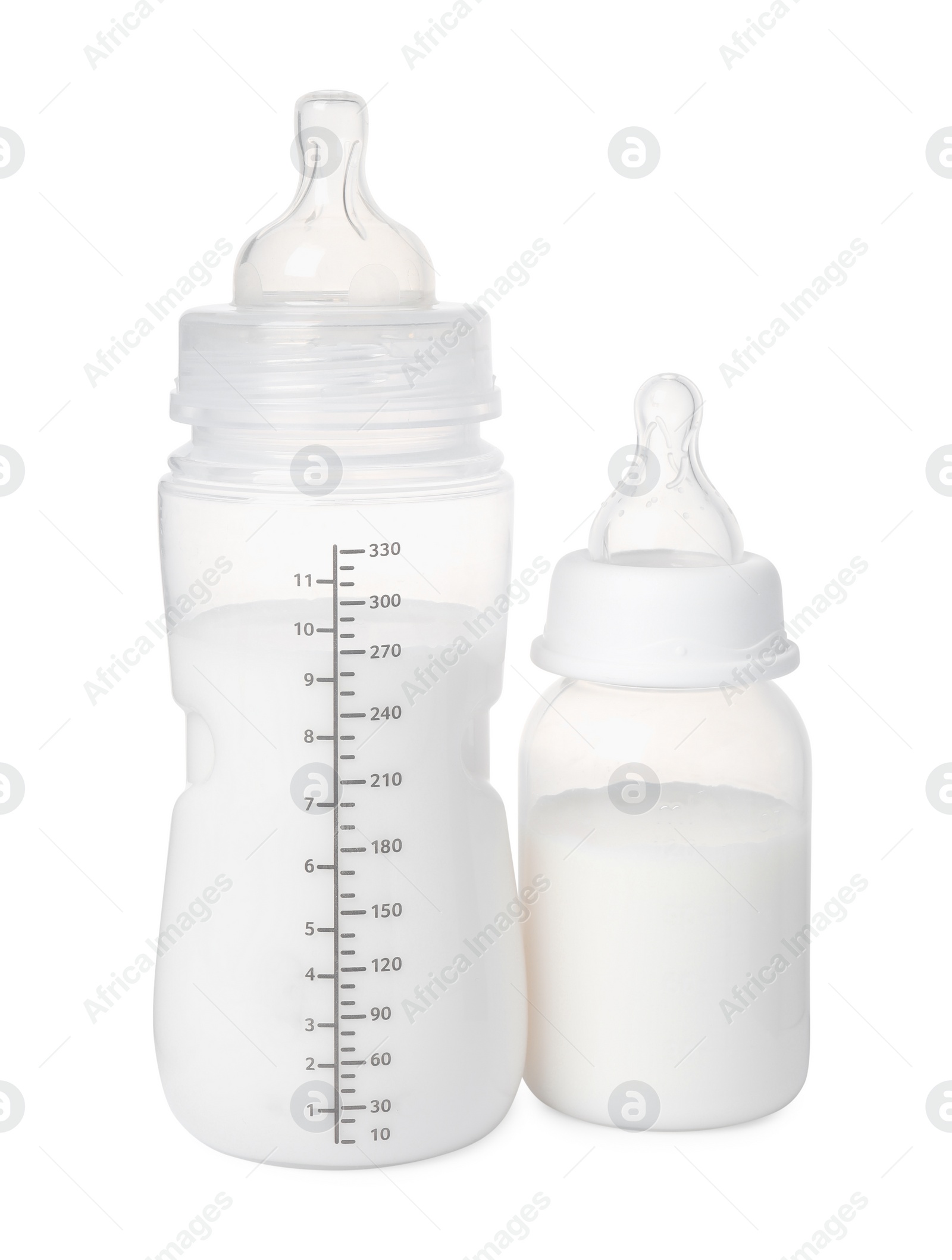 Photo of Two feeding bottles with infant formula on white background