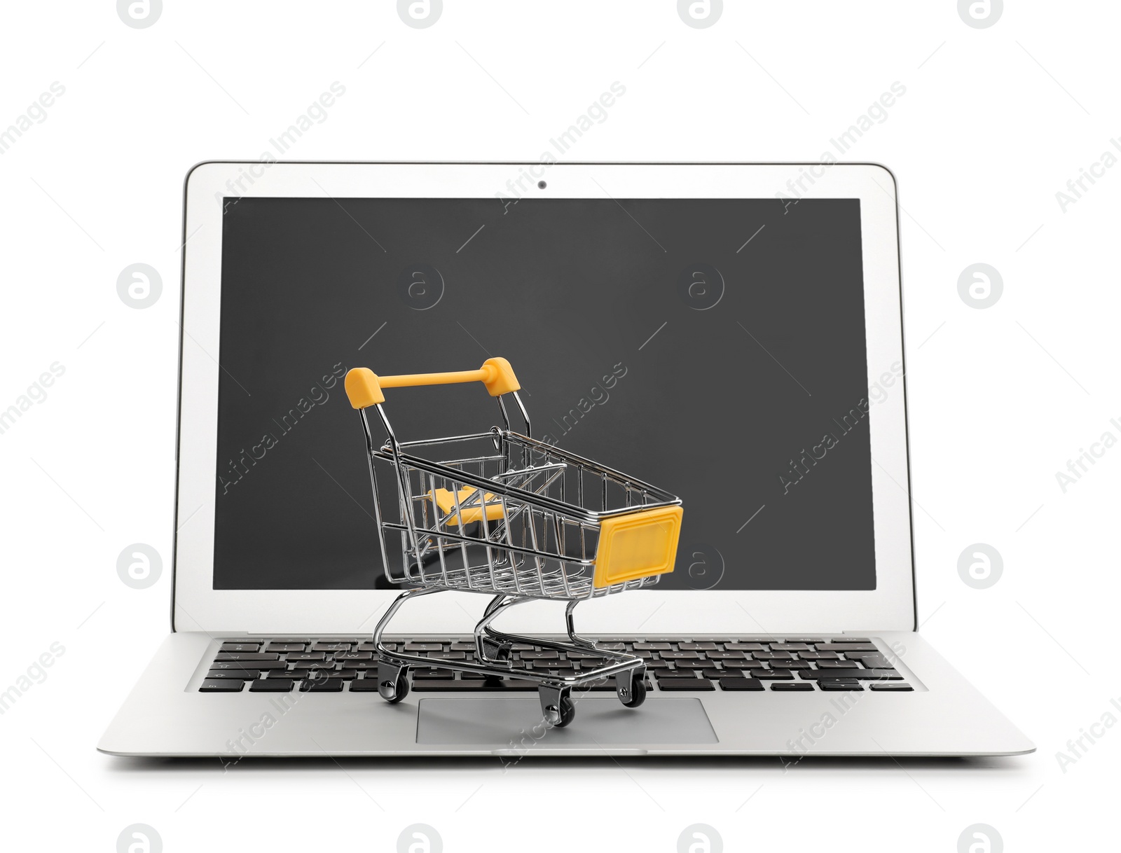 Photo of Internet shopping. Laptop with small cart isolated on white