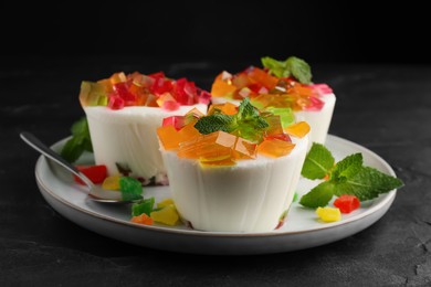 Photo of Delicious broken glass jelly dessert on black table