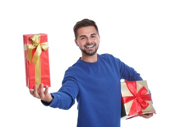 Photo of Happy young man holding Christmas gifts on white background