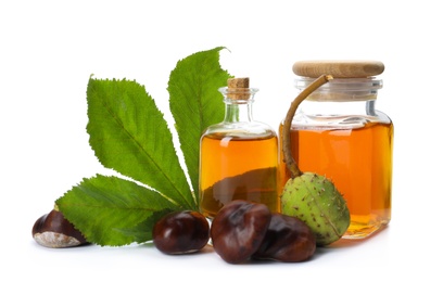 Photo of Horse chestnuts, bottles of tincture and green leaf on white background