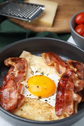 Delicious crepe with egg on table, closeup. Breton galette