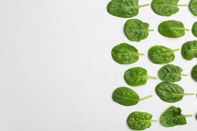 Photo of Fresh leaves of spinach isolated on white, top view