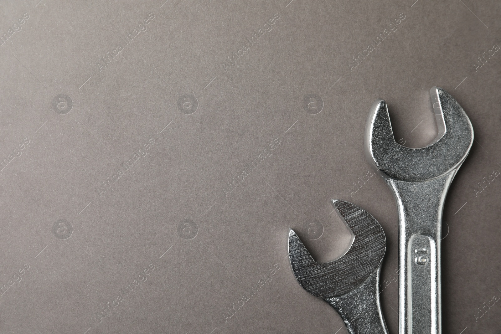 Photo of Auto mechanic's tools on grey background, flat lay. Space for text