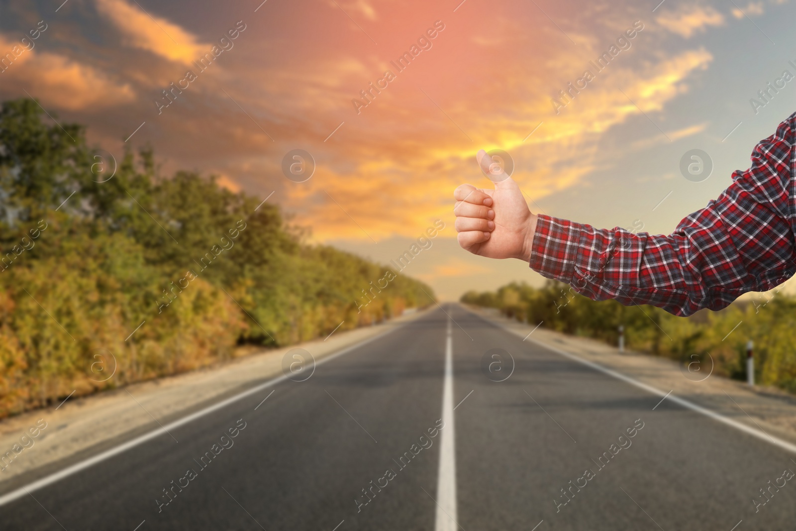 Image of Man catching car on road, closeup. Hitchhiking trip