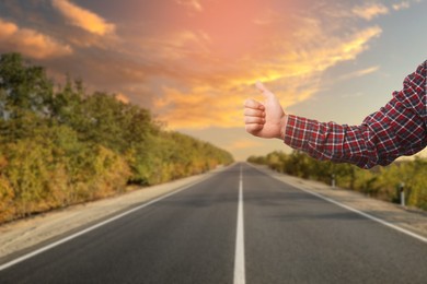 Image of Man catching car on road, closeup. Hitchhiking trip