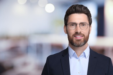 Image of Handsome confident man with eyeglasses in office, space for text