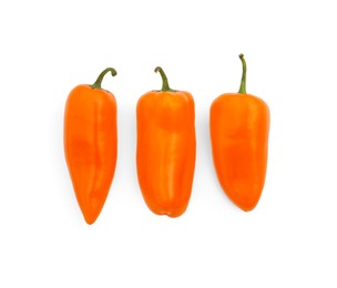 Fresh raw orange hot chili peppers isolated on white, top view