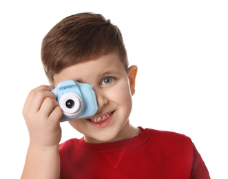 Little photographer taking picture with toy camera on white background