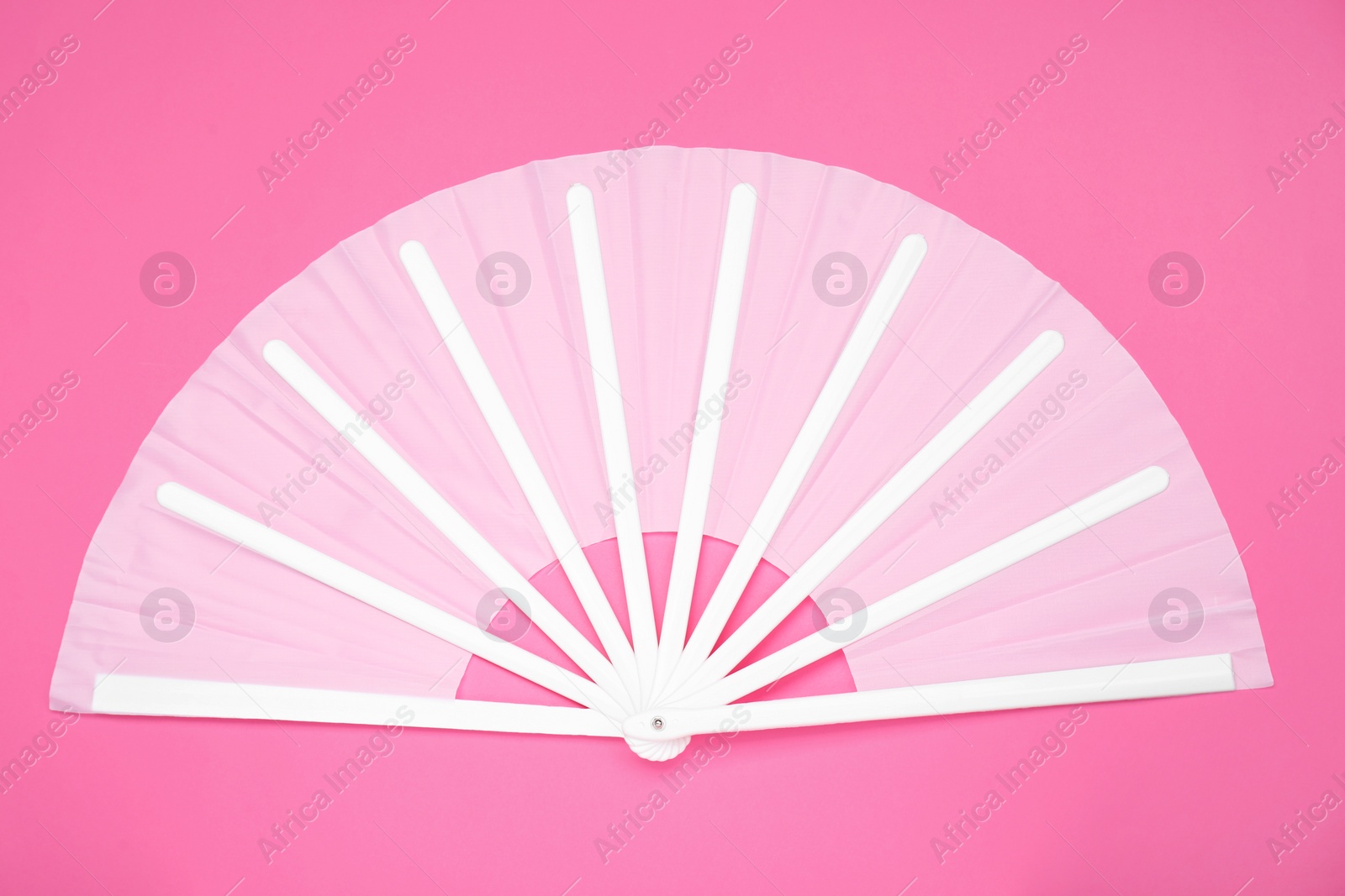 Photo of Stylish white hand fan on pink background, top view