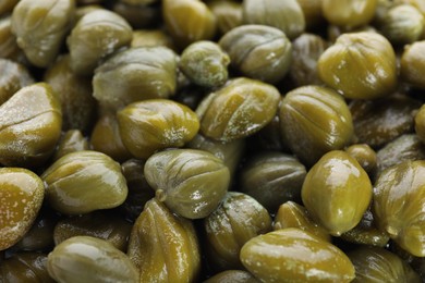 Pile of pickled capers as background, closeup view