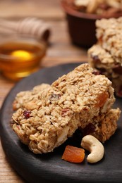 Photo of Tasty granola bars on table, closeup view
