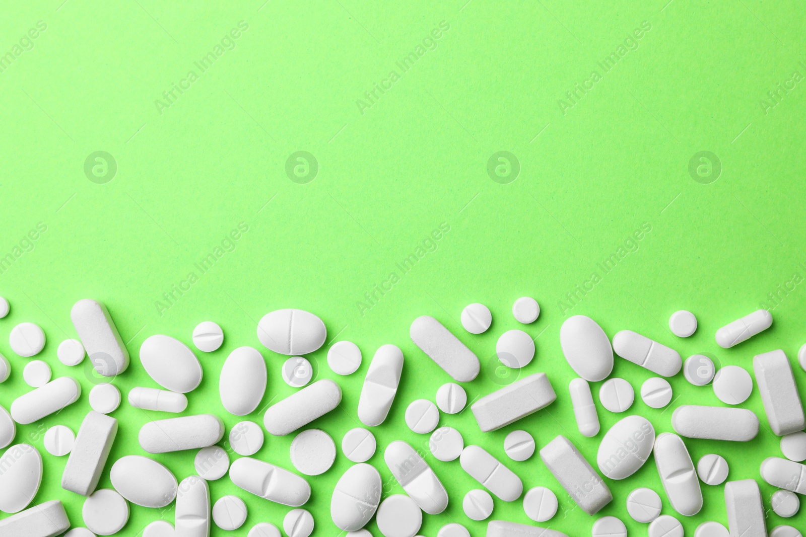 Photo of Different pills on color background, top view. Space for text