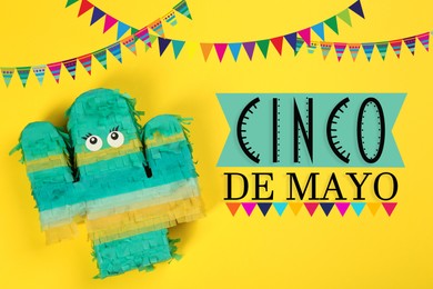 Image of Cinco de Mayo festive poster. Bright funny pinata on yellow background, top view