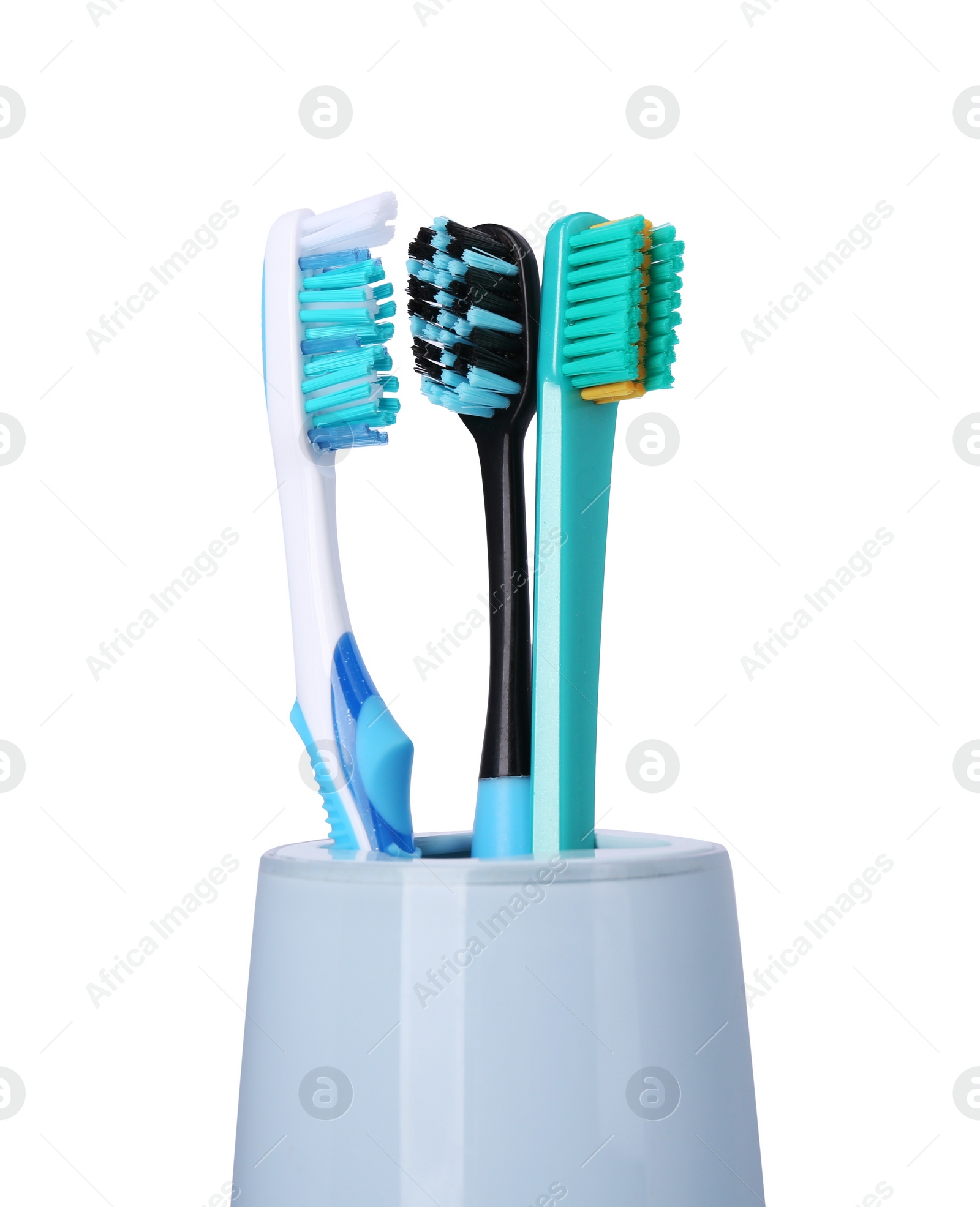 Photo of Different toothbrushes in holder isolated on white