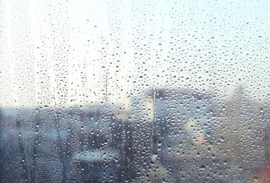 Blurred view of city from window on rainy day