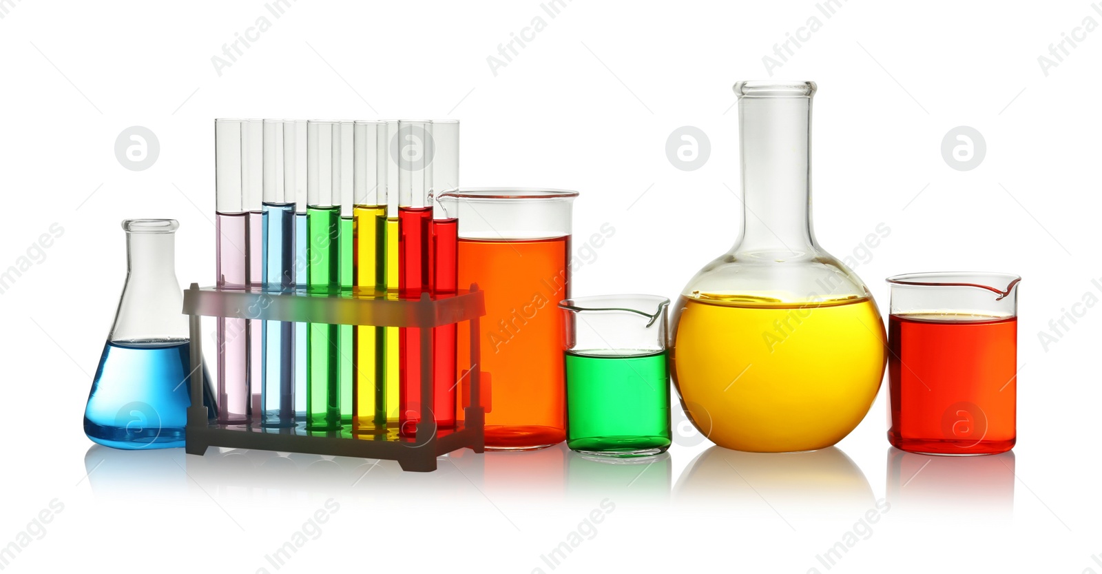 Photo of Laboratory glassware with colorful liquids on white background