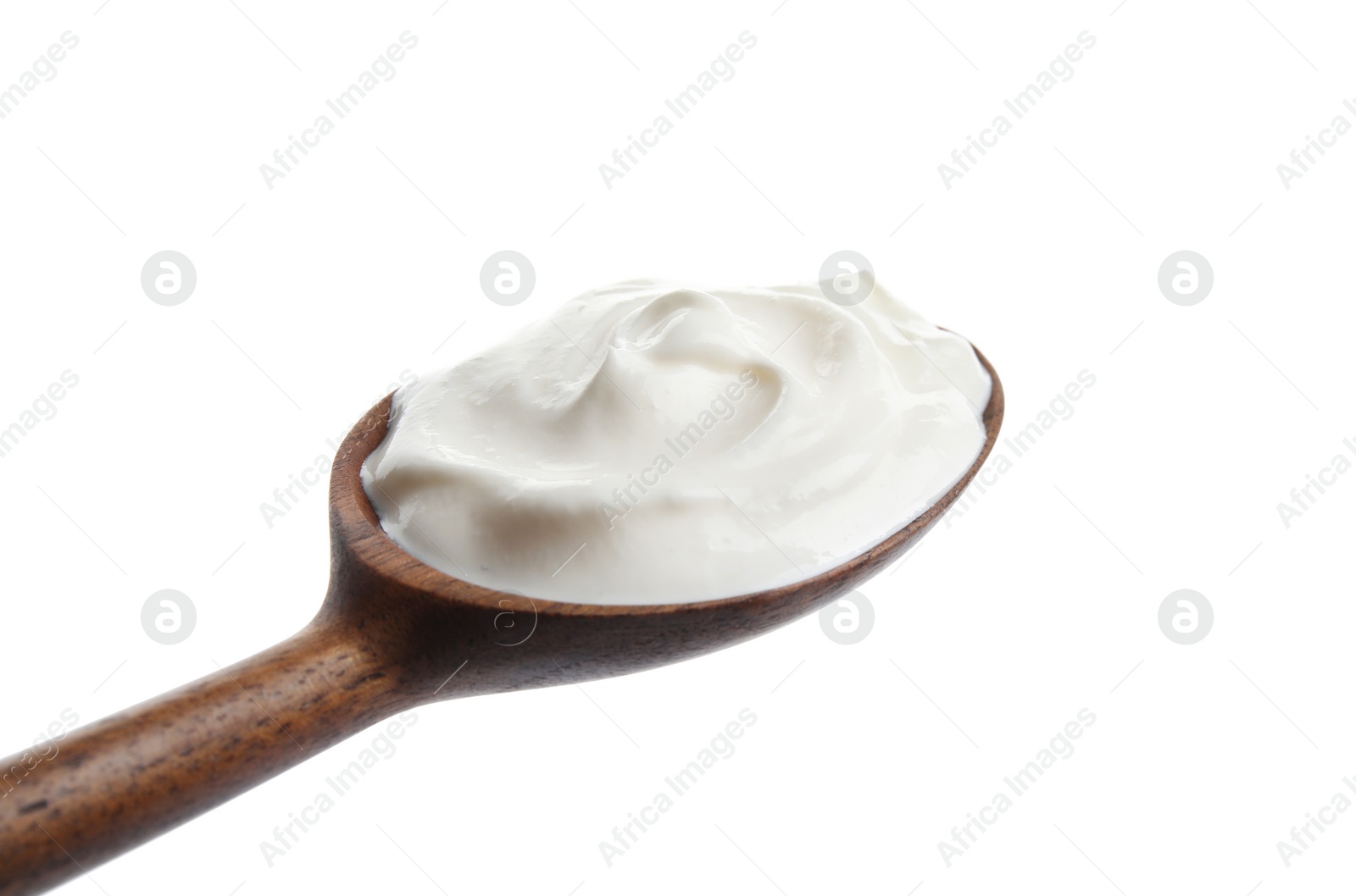 Photo of Wooden spoon with sour cream on white background