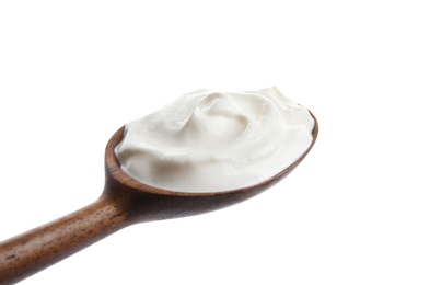 Photo of Wooden spoon with sour cream on white background