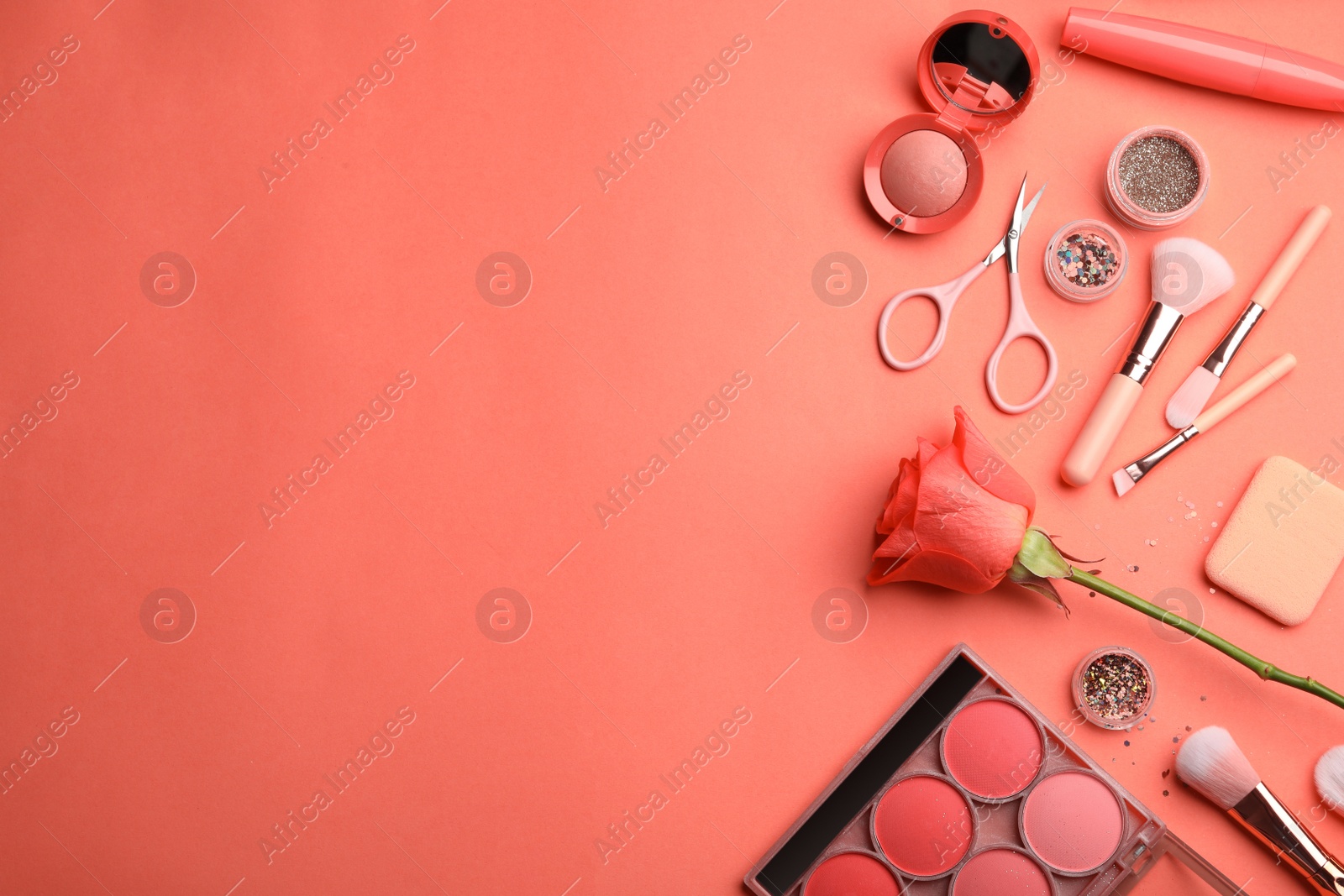 Photo of Flat lay composition with beauty accessories and space for text on coral background