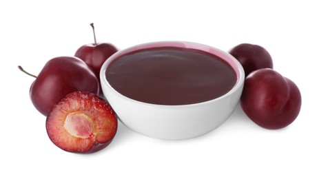 Photo of Plum puree in bowl and fresh fruits on white background