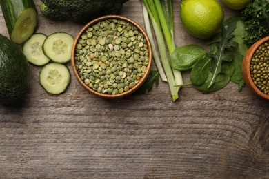 Photo of Different vegetables on wooden table, flat lay and space for text. Vegan diet