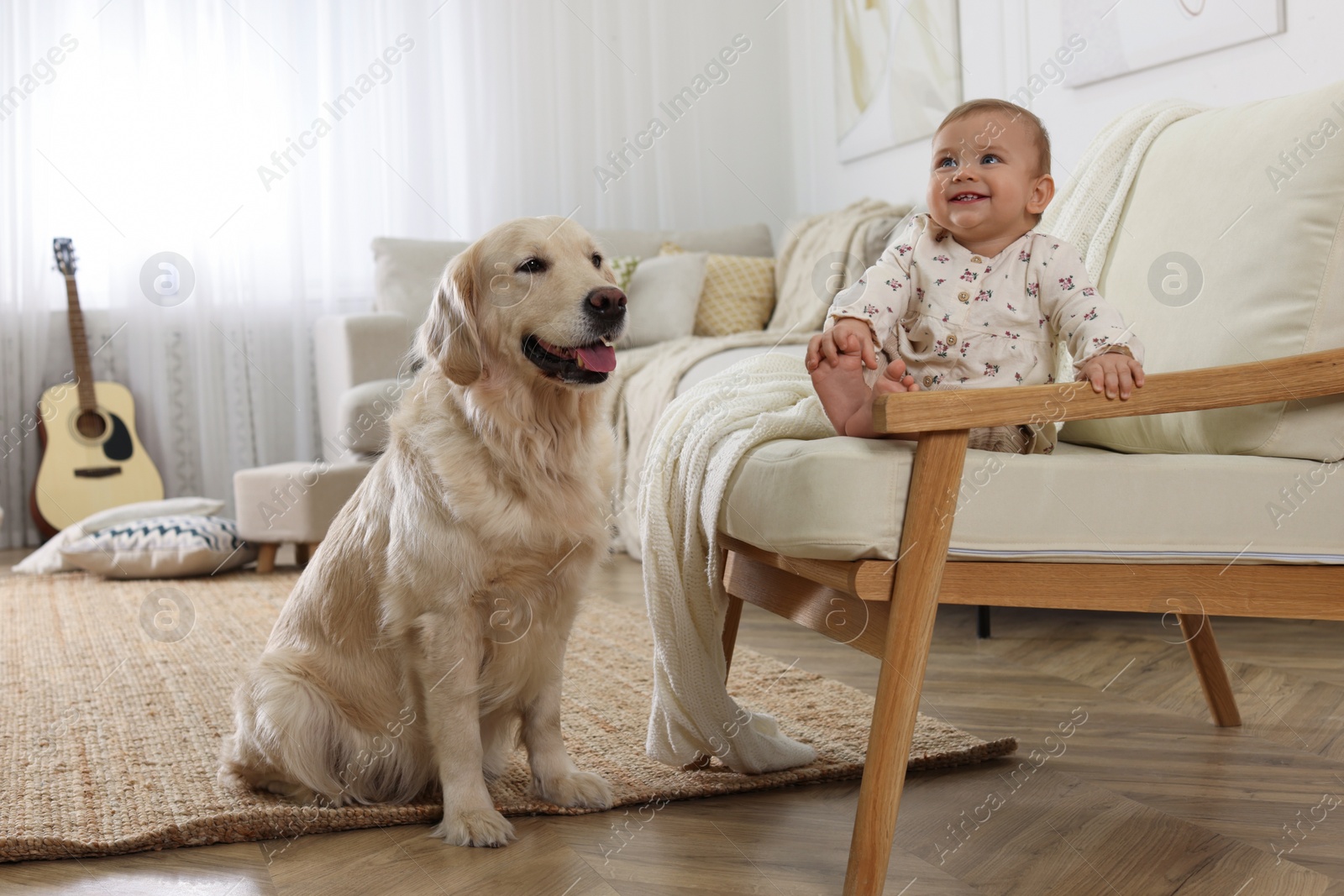 Photo of Cute little baby with adorable dog at home