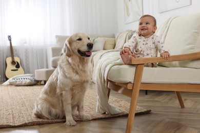 Photo of Cute little baby with adorable dog at home