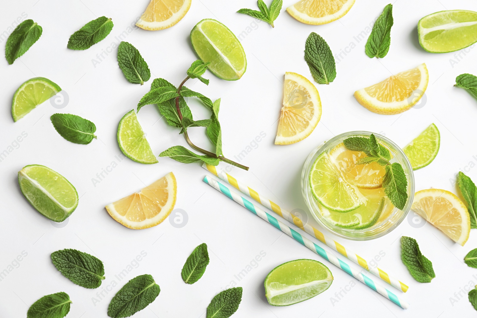 Photo of Flat lay composition with delicious natural lemonade on white background